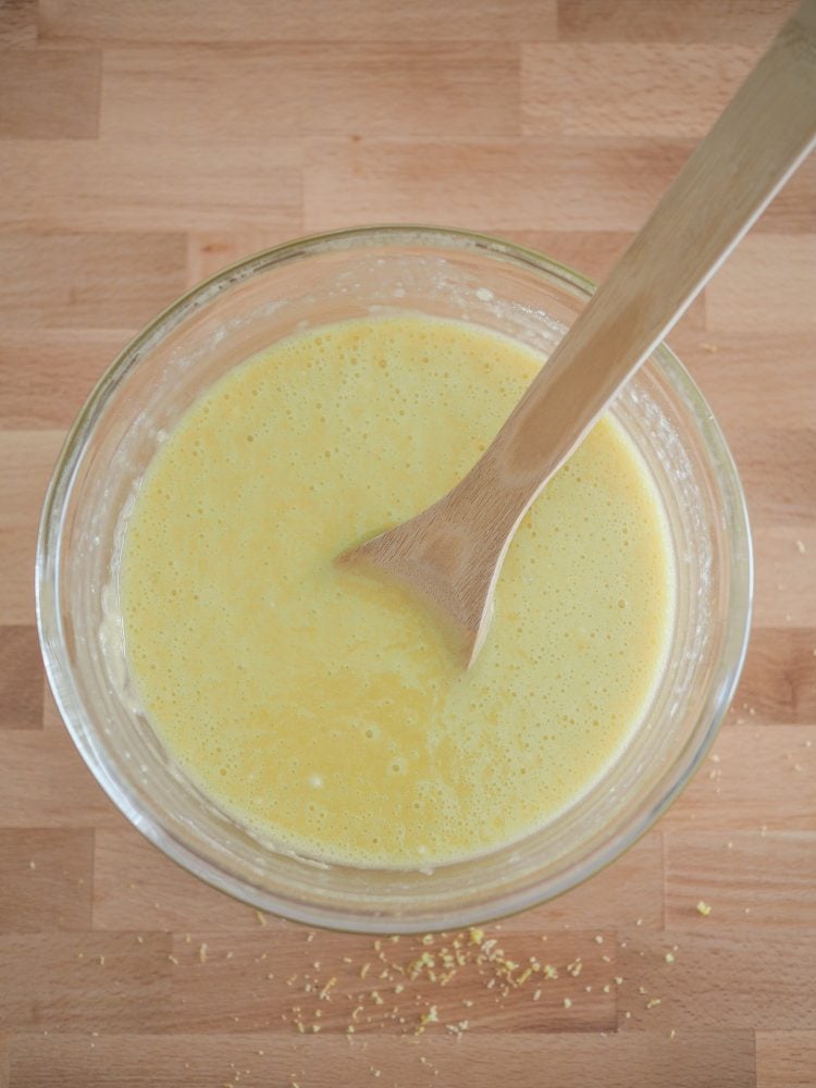 Overhead shot of wet ingredients mixed together to form a yellow batter.