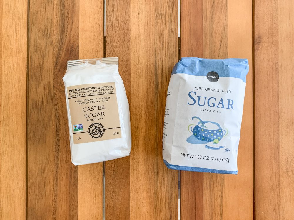 A bag of caster sugar and a bag of granulated sugar.