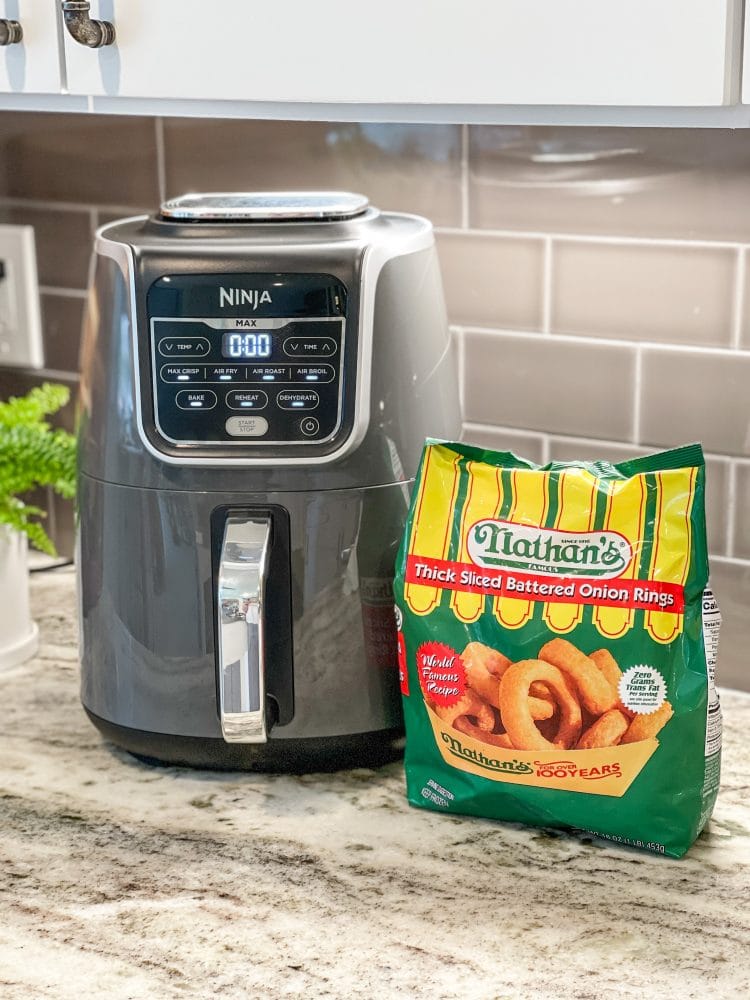 Ninja XL air fryer with a bag of Nathan's frozen onion rings.