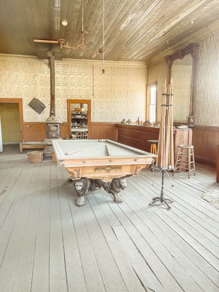 Dusty billiards table and bar inside one of the old saloons in Bodie State Park.