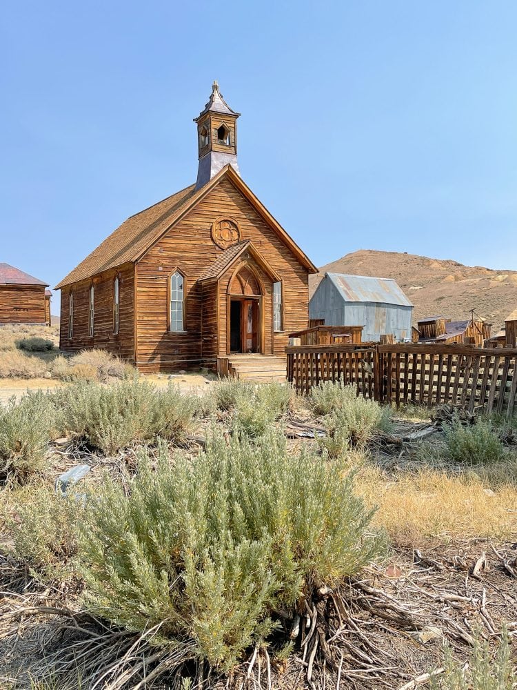 The old church in Bodie State Park. It's simple, made of wood with a small entrance and church bell steeple.