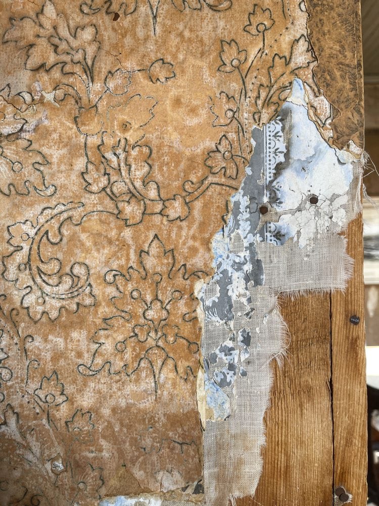 Closeup of layers of wallpaper peeling inside the Miller House.
