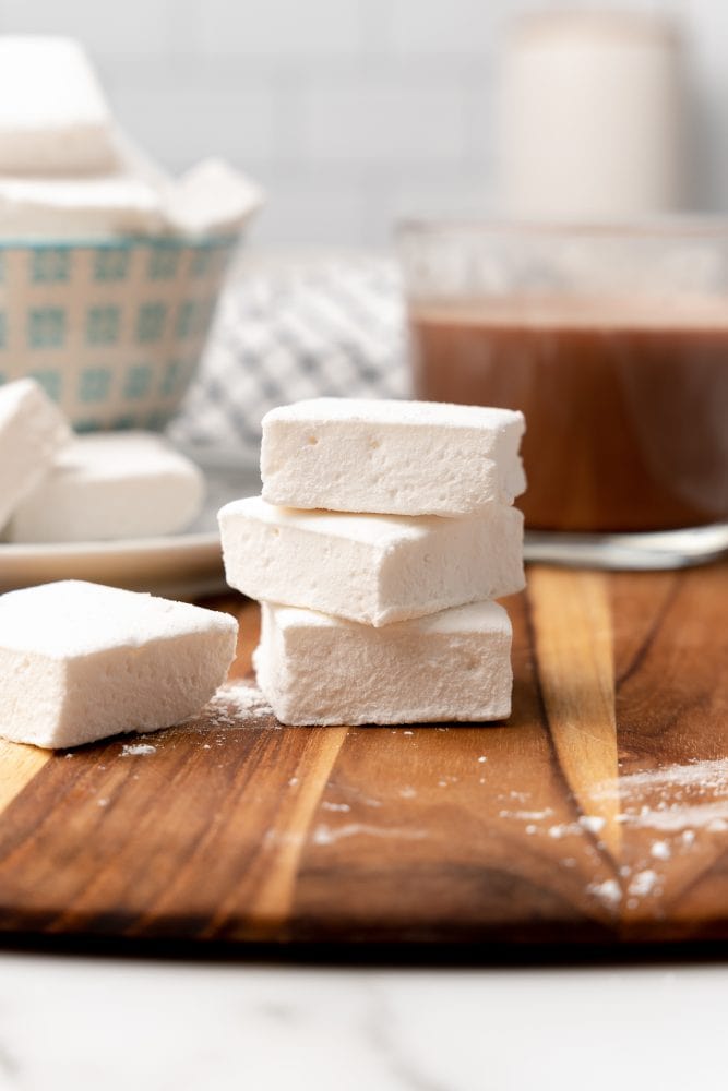 stack of homemade marshmallows on a wood cutting board