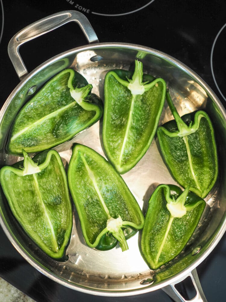 Poblano peppers in a saute pan.