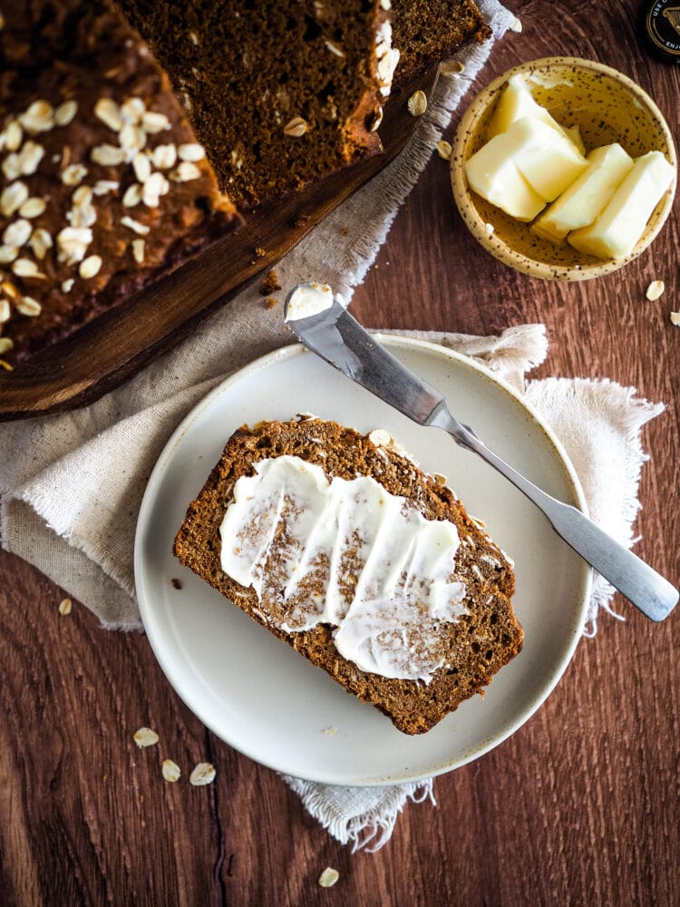 overhead view of slice of Irish brown bread with a smear of butter
