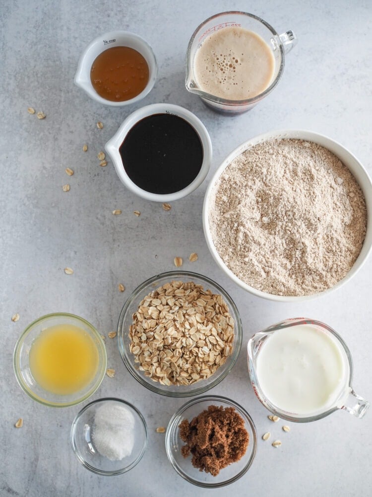 Ingredients meausred out to make Irish brown bread including honey, molasses, guinness, whole wheat flour, rolled oats, buttermilk, melted butter, dark brown sugar, salt, and baking soda.