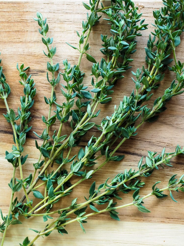 fresh thyme on a wood cutting board