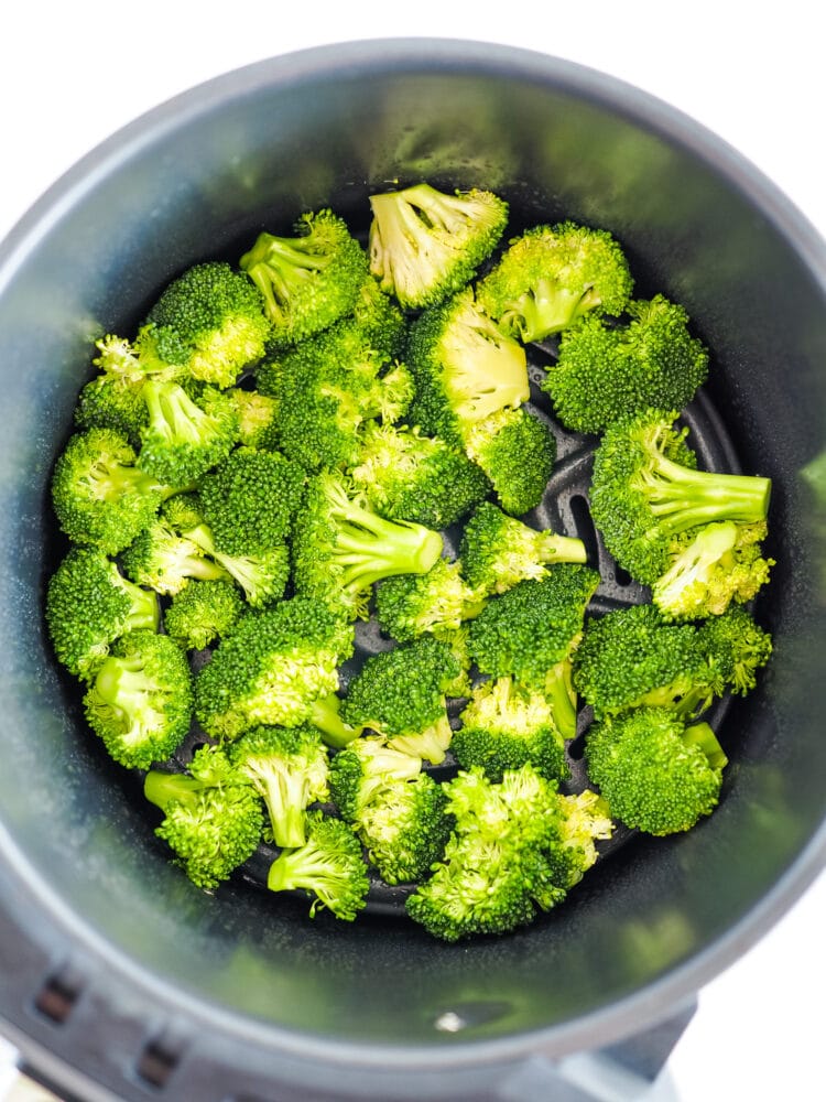 Raw broccoli inside a Ninja air fryer basket.