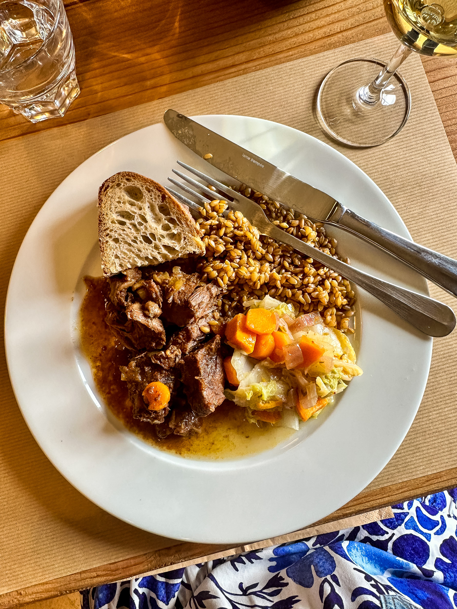 Rustic French lunch of beef stew, steamed organic garden vegetables of carratos and cabbage, farro, and homemade bread.