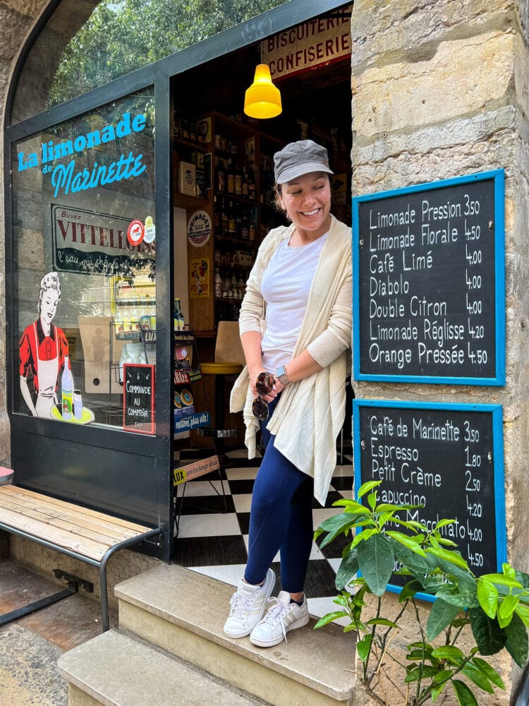 Rachelle looking at a refreshing lemonade menu on the outside of a cafe in Lyon, France.