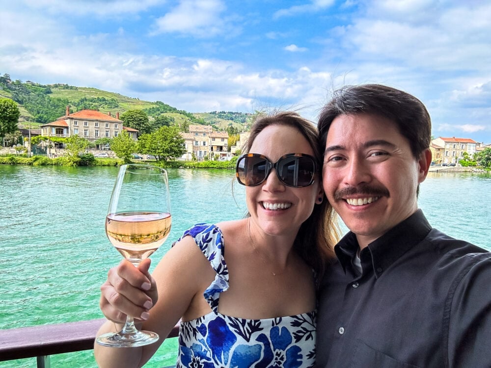 Rachelle and Pete enjoying views of the Rhone river from their stateroom balcony on a Viking River Cruise.