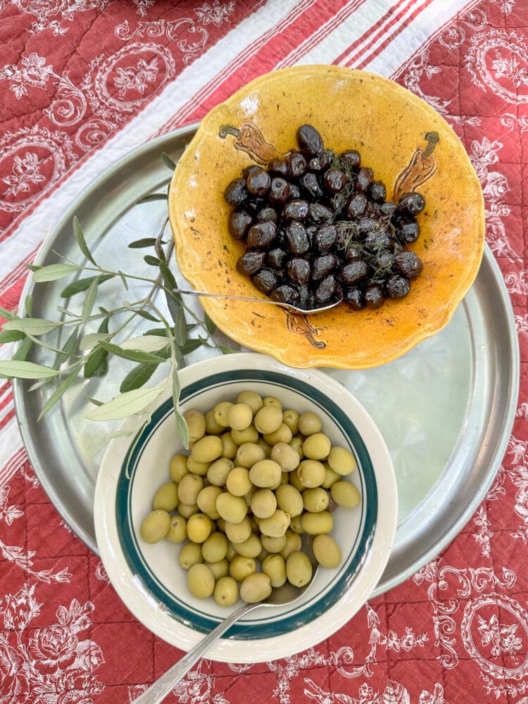 Provencial olives: black olives in a yellow bowl and green olives in a white bowl.
