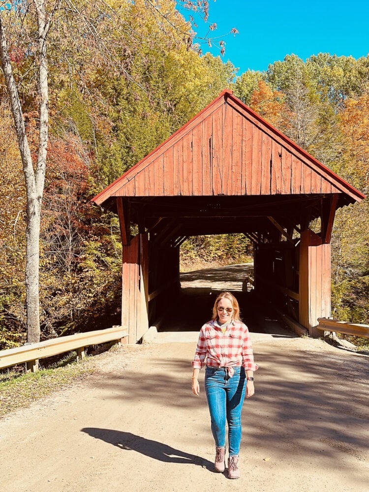 Rachelle walking in front of Red Bridge in Stowe, VT