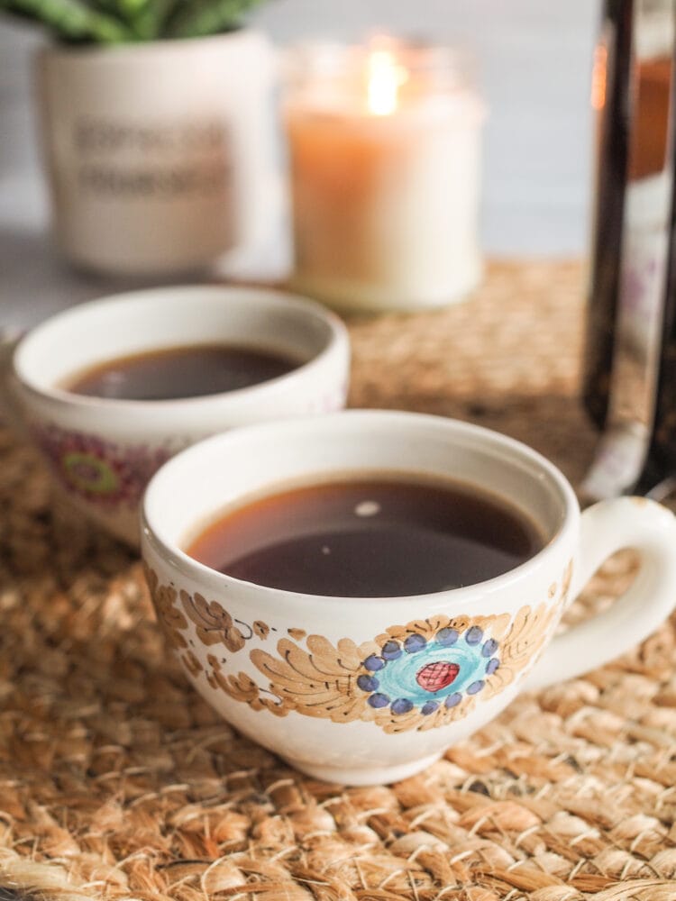 small cup of cardamom coffee in a cermamic cup painted with blue and brown flourish