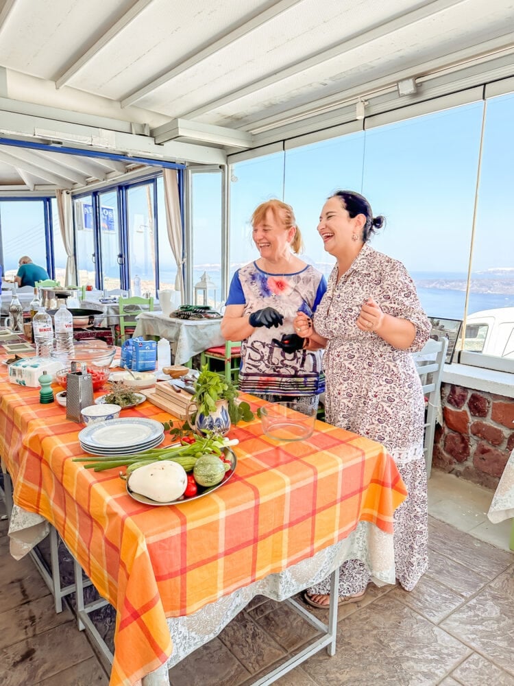 Ms Lista and Ms Rena teaching a cooking class at Taverna Aeolus in Santorini, Greece.