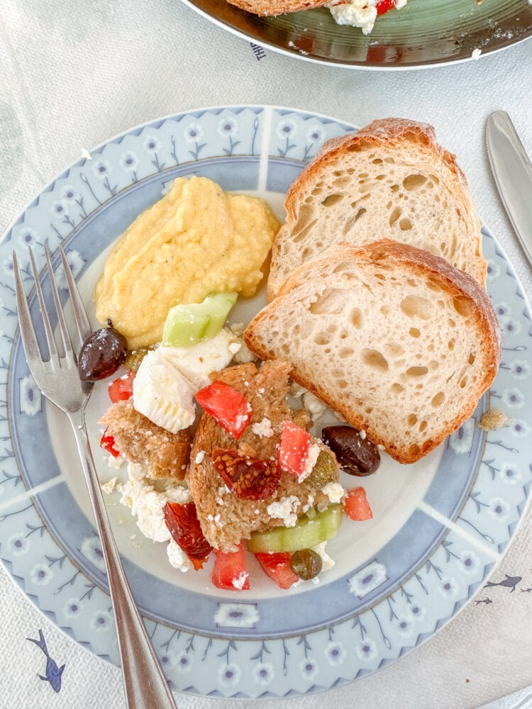 A small plate of dakos salad, bread, and Greek fava dip at Aeolus Tavern in Santorini.