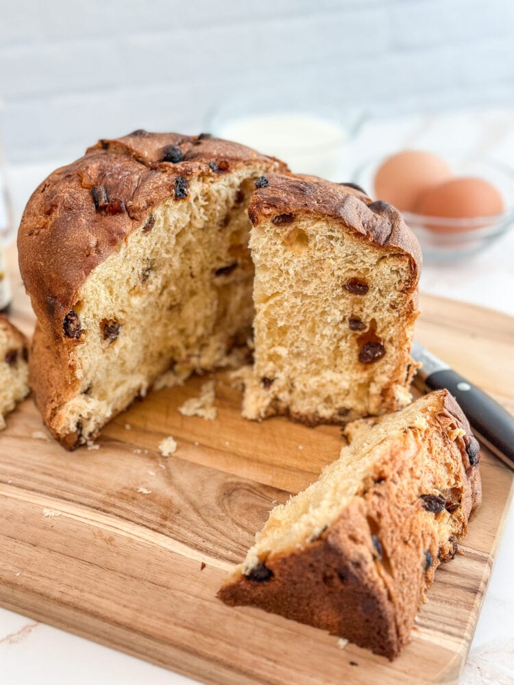 Side view of a sliced panettone showing the raisins, candied orange, and walnuts.