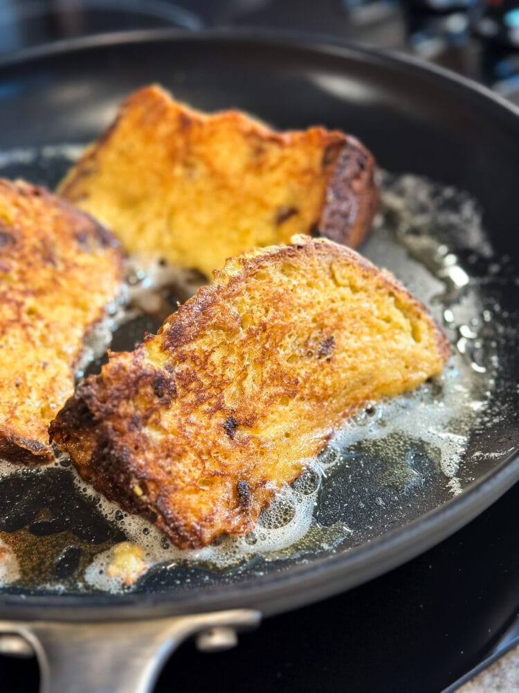 Close up of panettone french toast cooking in skillet.
