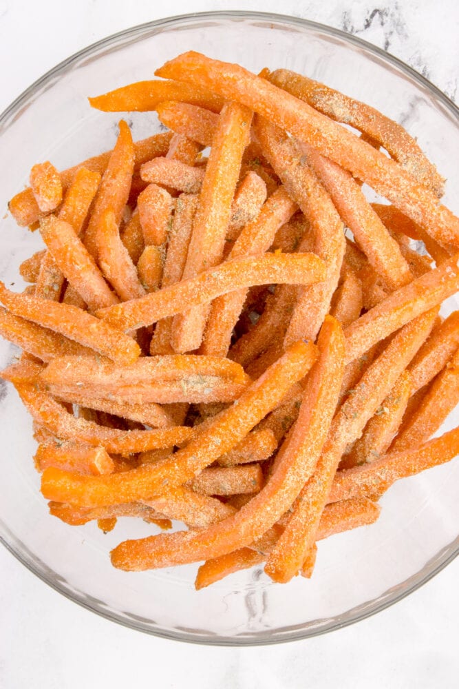 close up of frozen sweet potato fries in a clear glass bowl