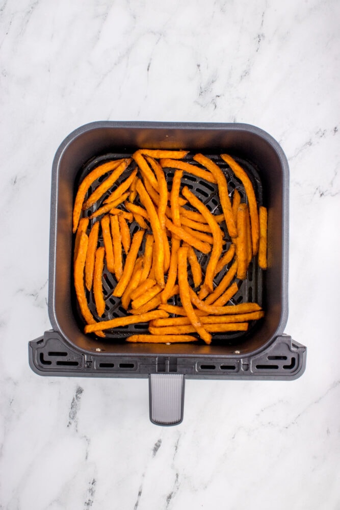 air fried frozen sweet potato fries in a square air fryer basket
