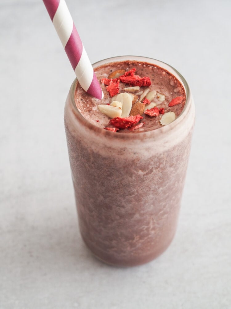 Chocolate protein shake topped with crushed freeze dried strawberries and slivered almonds.