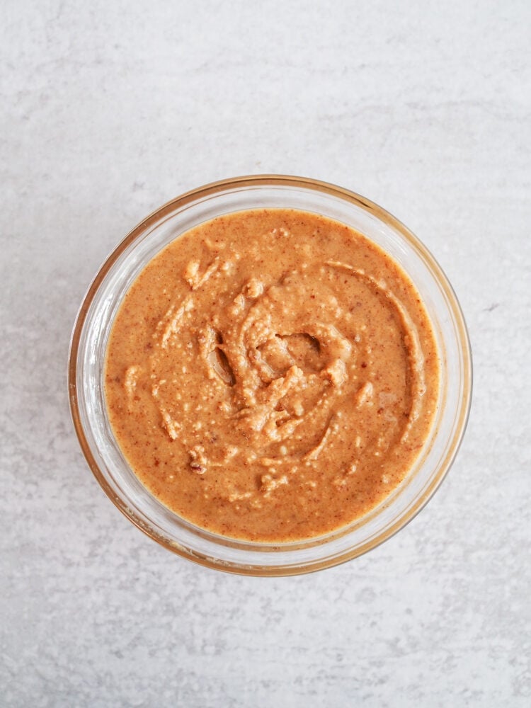 Fresh ground peanut butter in a glass bowl.