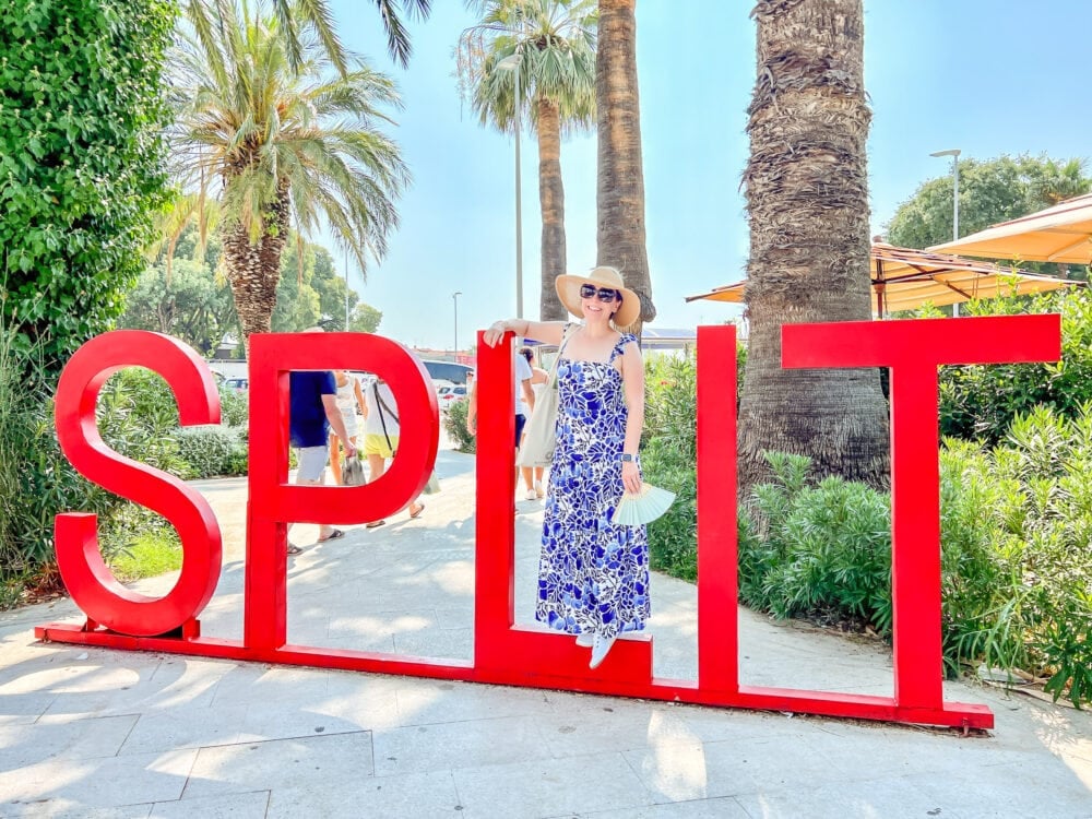 Rachelle standing on a large red sign that reads "Split"