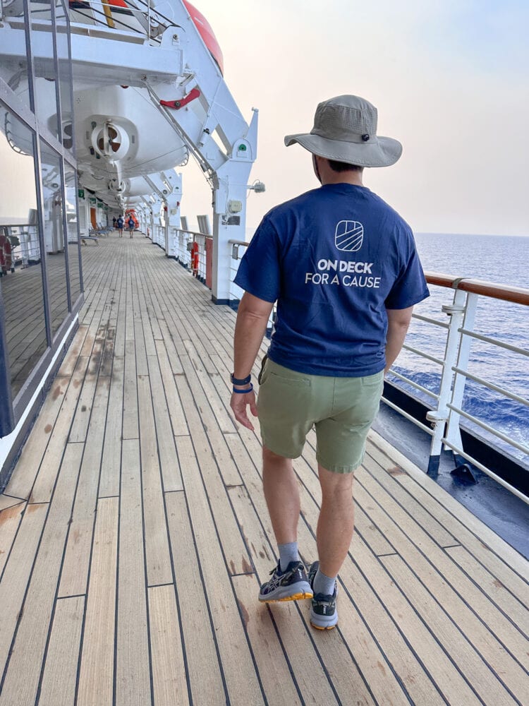Pete walking on deck with a blue shirt that says "On Deck For A Cause"