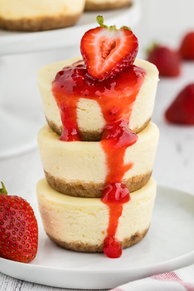 stack of mini cheesecake bites with strawberry sauce