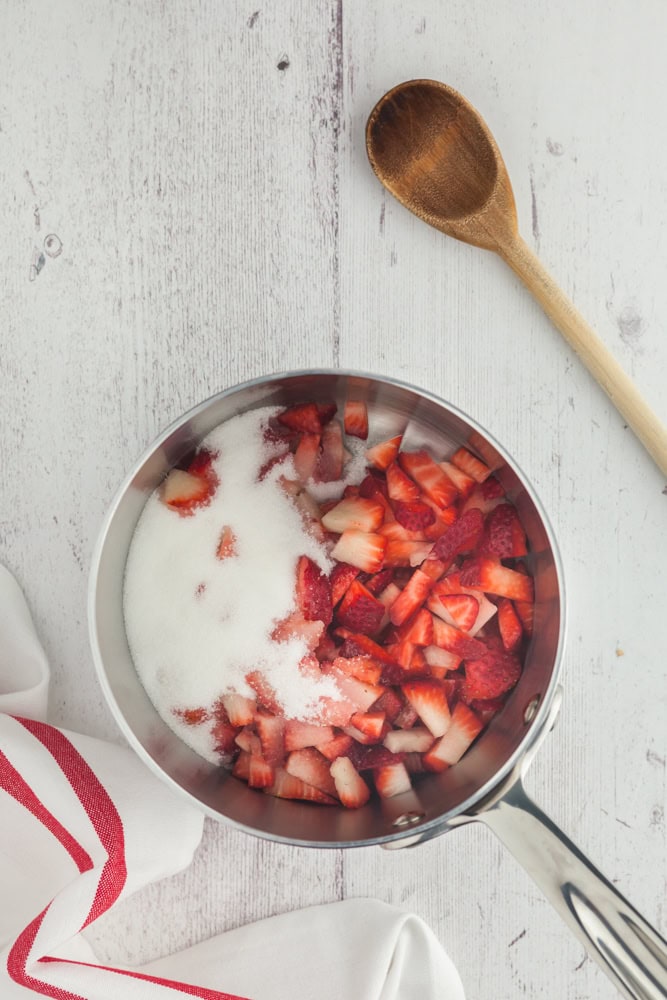 diced strawberries and sugar in a sauce pan