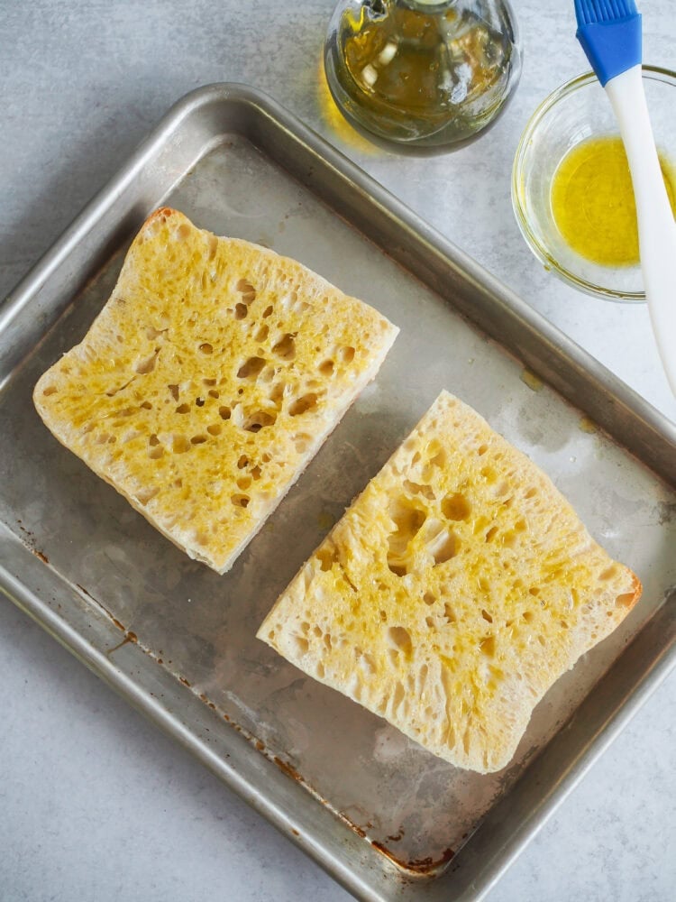 bread on a sheet pan brushed with olive oil