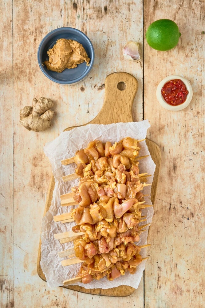 marinated chicken on skewers before grilling