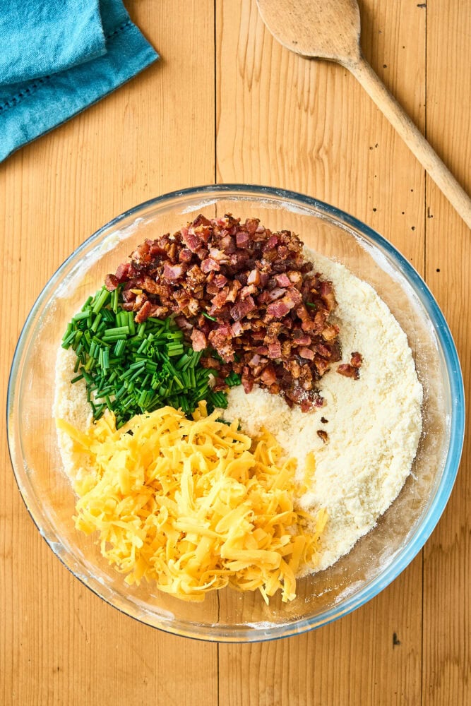 cheddar, chives, and bacon on scone dough in a bowl