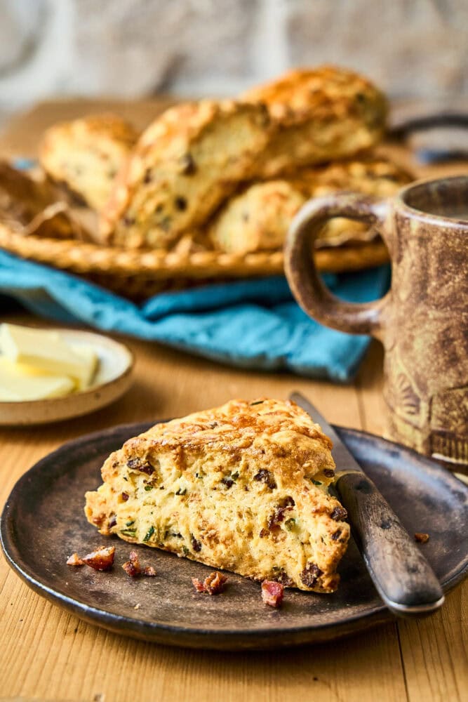 bacon cheddar scone on a plate with a butter knife