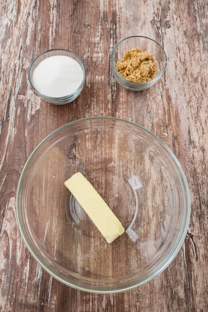 butter and sugars next to a mixing bowl ready to mix together