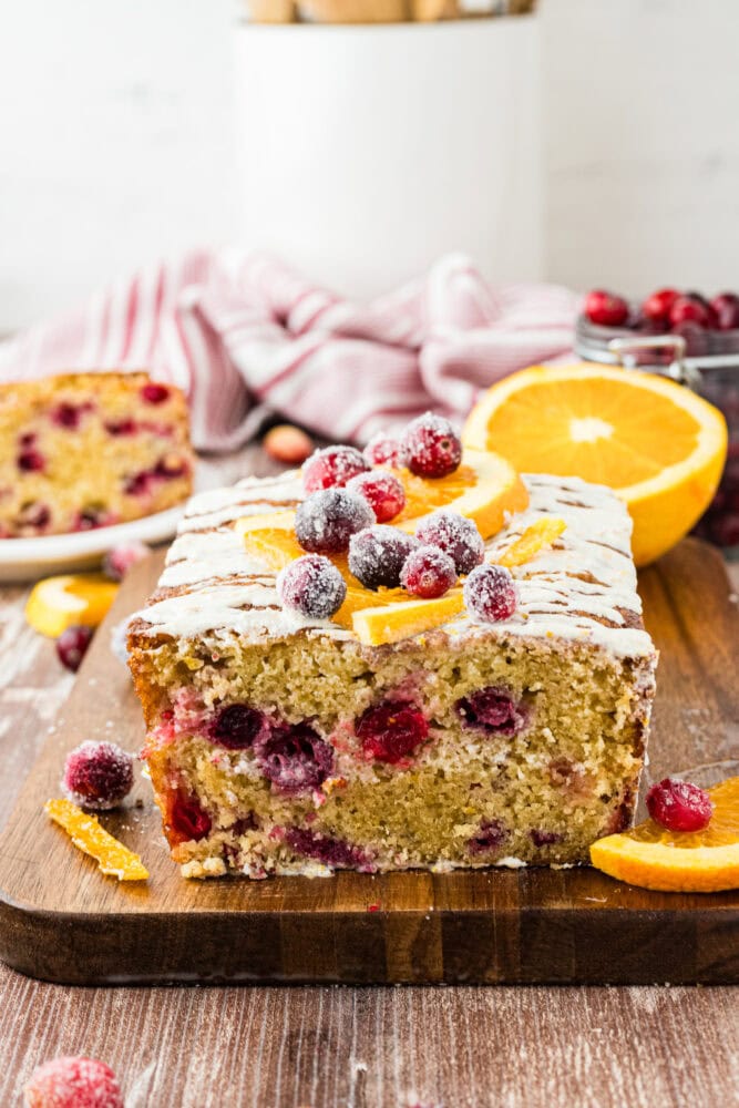 Side view of cut cranberry orange loaf showing the cranberries inside