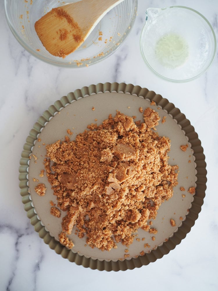 Adding crust crumb mixture to tart pan