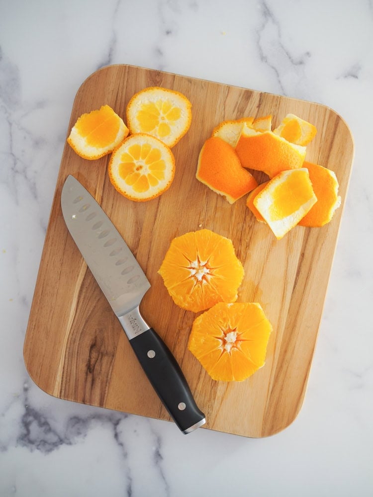 preparing orange for juicing by removing peel