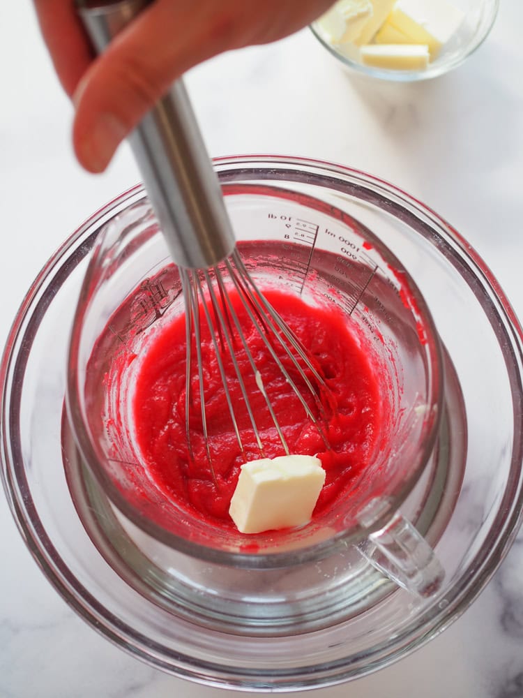 Adding butter to cranberry sauce juice