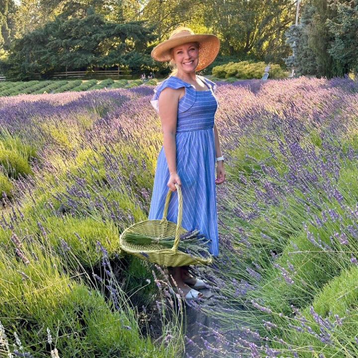 Rachelle standing in lavender fields at Wayward Winds