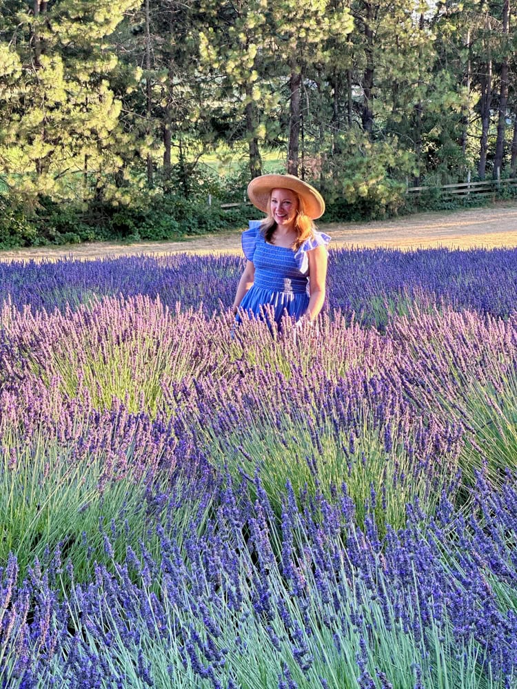 Rachelle walking in a field of lavender at wayward winds farm