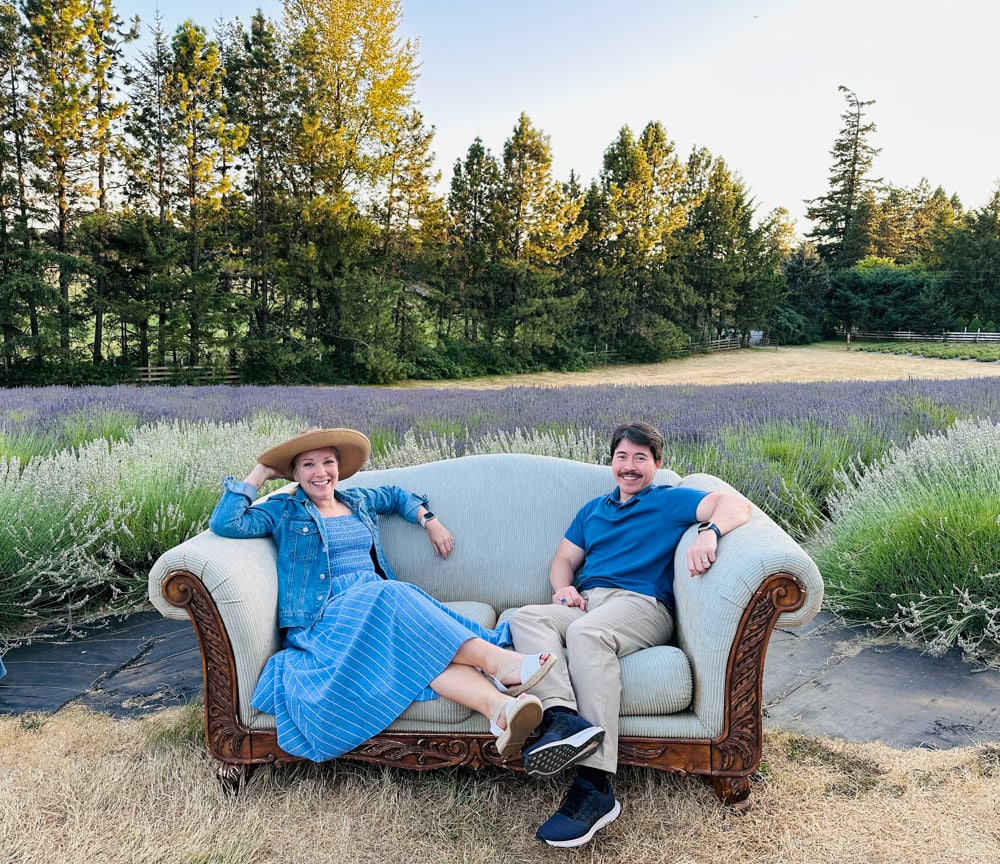 Rachelle and Pete sitting on a couch at Wayward farm