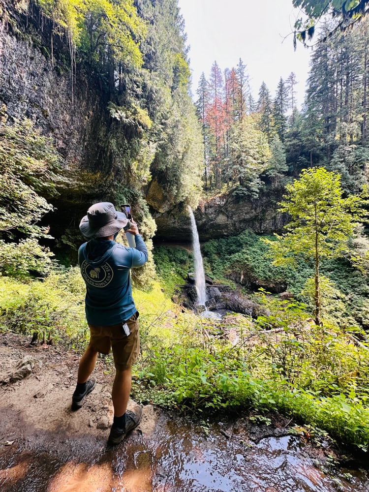 Pete taking a picture of a waterfall