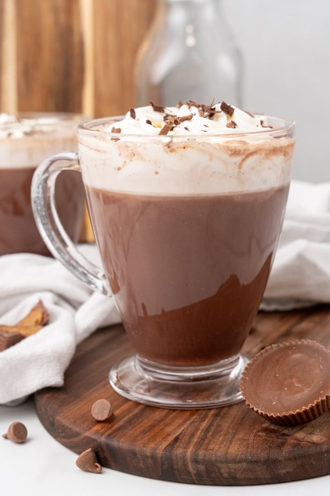 peanut butter hot chocolate in a clear glass mug