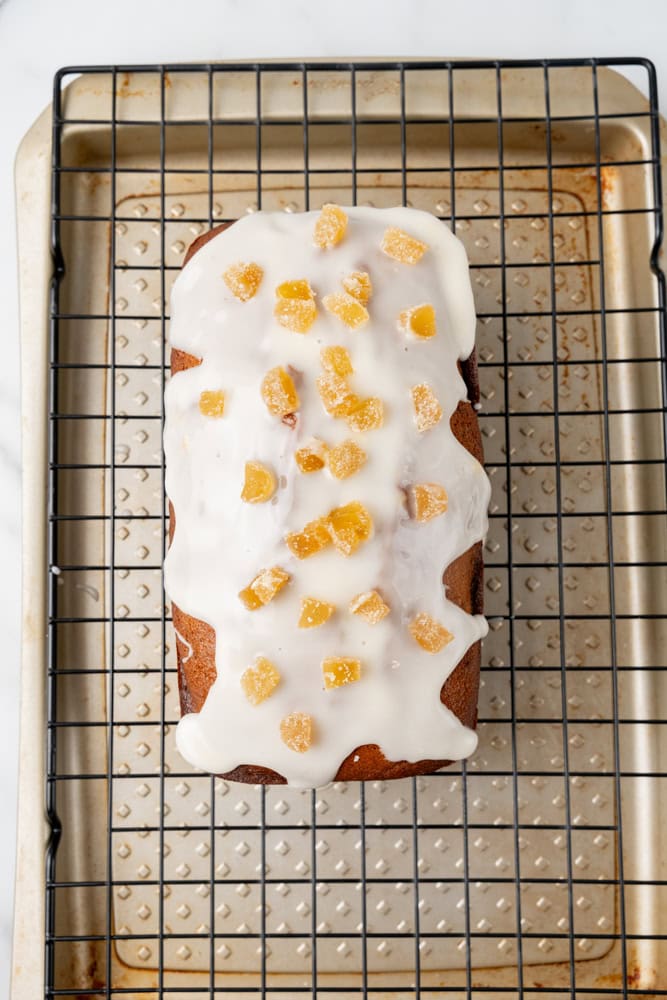 gingerbread loaf topped with glaze and candied ginger