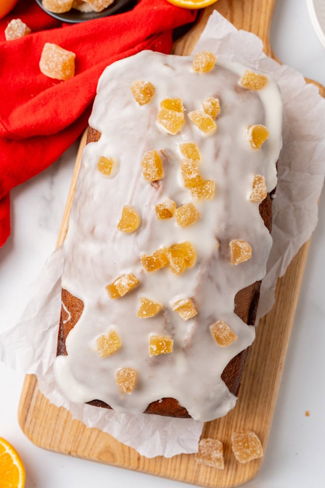 overhead look at a gingerbread loaf with orange glaze and candied ginger