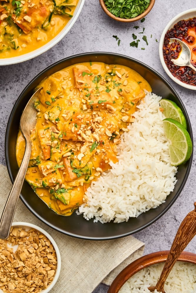 Thai pumpkin curry with rice and lime wedges