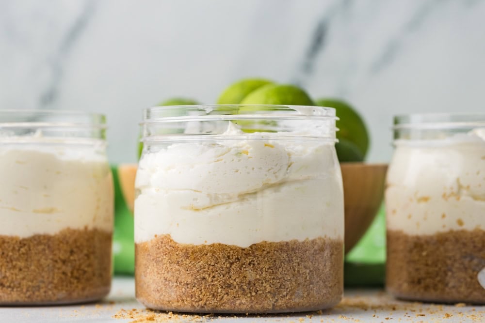 Side view of jar with crust and key lime cheesecake filling