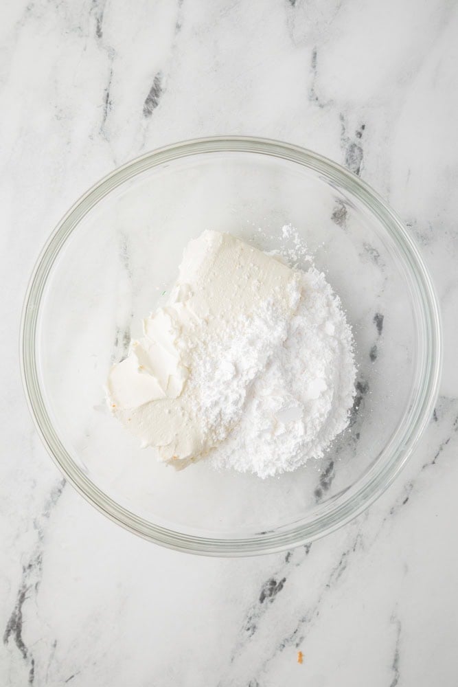 powdered sugar and cream cheese in a glass bowl