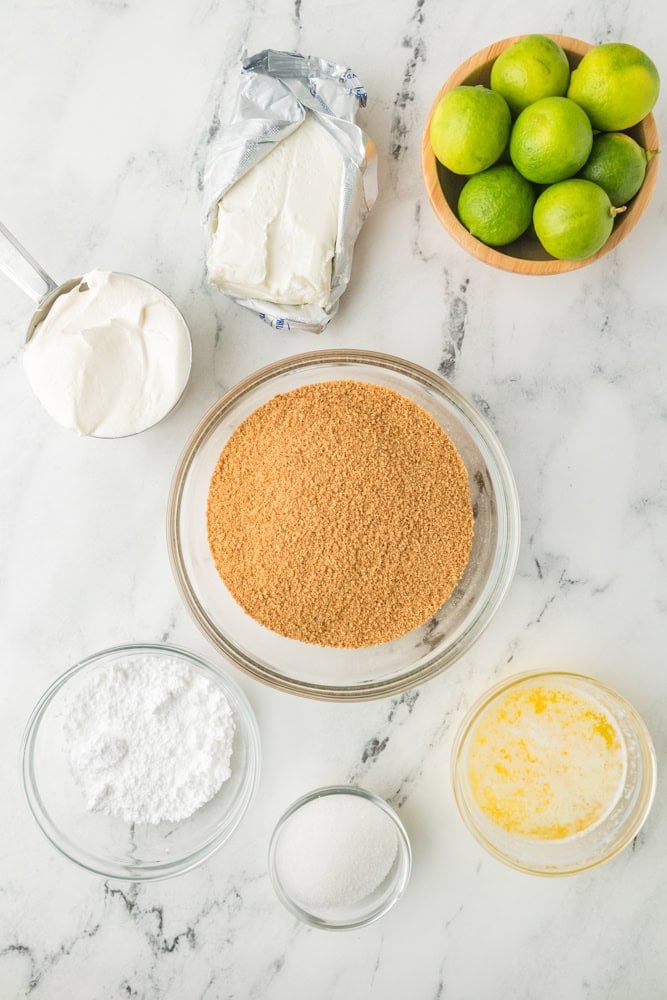 Ingredients to make no bake key lime cheesecake measured out  and placed in glass bowls